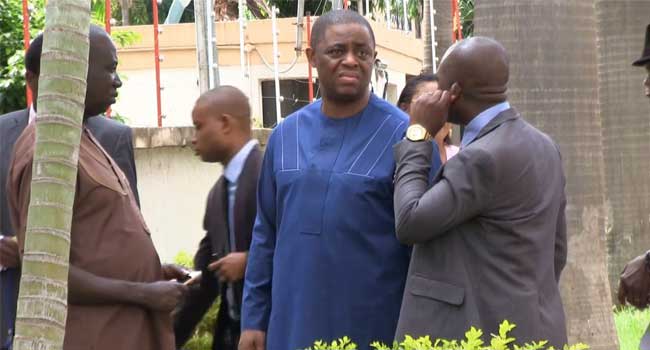 "Femi-fani kayode standing with two men"