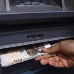 An ATM dispensing money