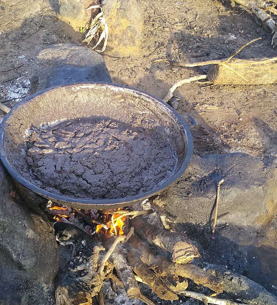 The dark brownish paste placed in an open flame. 