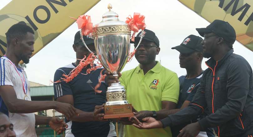 John Obaro,Managing Director, SystemSpecs, owners of Remita (m); Emmanuel Ocholi, Director, Board of SystemSpecs (2nd right); Jimmy Shogbesan, Chief Operating Officer, MediaVision limited (right) and Peter Rufai, Tournament Ambassador, Remita Corporate Champions Cup (RC3) presenting the trophy to Akintade Ekundayo, Captain, Unilever football team at the finale of the 2019 RC3 tournament in Lagos on Sunday