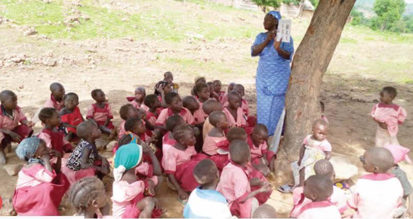 Nigerian children learning under trees in the 21st Century!