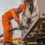 '' A man pumping diesel in a machine''
