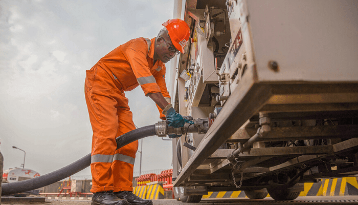 '' A man pumping diesel in a machine''