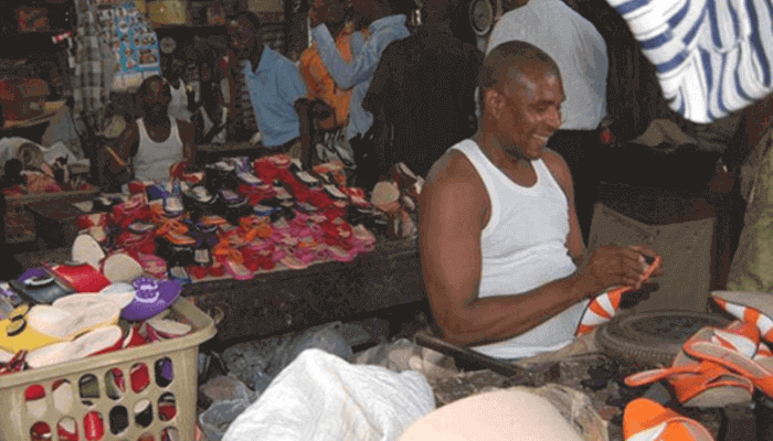 "A seller in front of his goods"