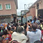 "people gather around looking at the helicopter crash"