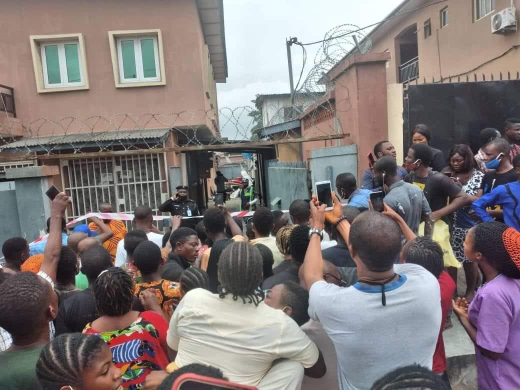 "people gather around looking at the helicopter crash"