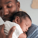 "Potrait of a father carrying a baby"