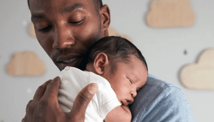 "Potrait of a father carrying a baby"