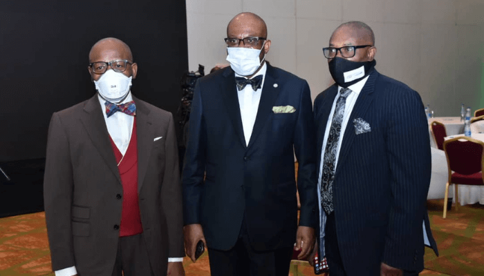 "three men on a suitt wearing a mask"