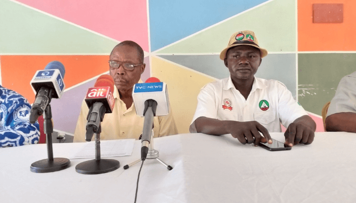 "two officers on a desk giving a speech"