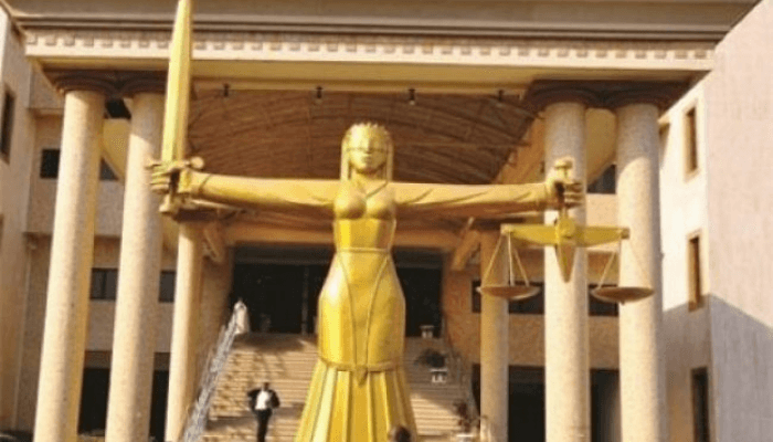 "lady justice in front of a court house