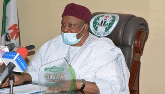 "Governor of taraba state sitting on his office chair"