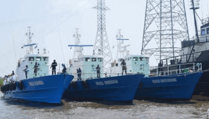 "Three ships by a dock"