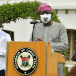 A man speaking in front of a microphone