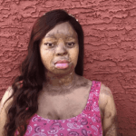 A lady standing by the wall