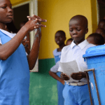 students washing their hands