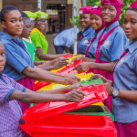 students holding waste bins