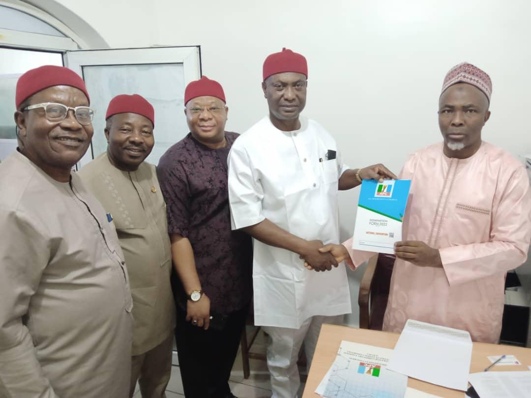 Henry Ikoh (2nd r) brandishing his form, while other party leaders look on.