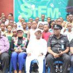 Edet Amana flanked by officials and 137 kids at booth camp