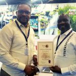 Didier Bayeye (left) receiving the ATB Global Aambassador certificate from Cuthbert Ncube