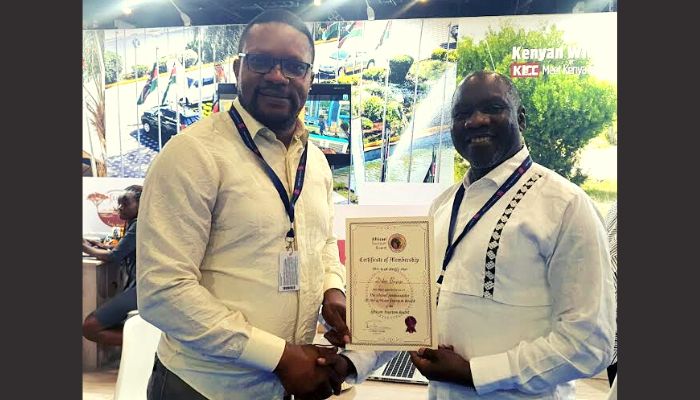 Didier Bayeye (left) receiving the ATB Global Aambassador certificate from Cuthbert Ncube