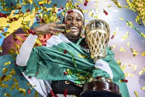 happy nigerian woman with trophy
