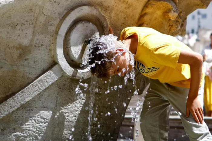 girl pouring water on her head