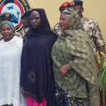 rescued girl standing with soldiers