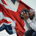 British flag and a depressed man