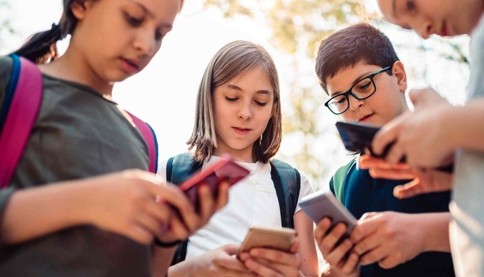 School kids using their phones