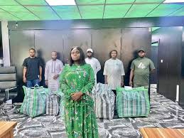 Charity Ijese Omole with bags of signatures at the INEC office