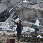 A rescuer gives instruction at the site of an under-construction high-rise building that collapsed on Friday after an earthquake in Bangkok, Thailand, Saturday, March 29, 2025. (AP Photo/Manish Swarup)