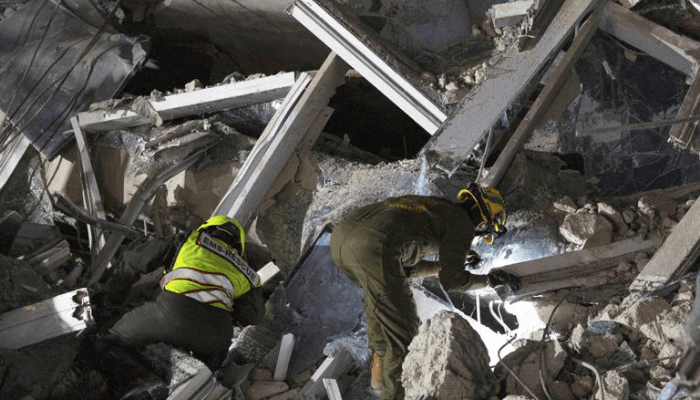 Rescuers search for victims at the site of a high-rise building under construction that collapsed after a strong earthquake in Bangkok, Thailand, early Saturday, March 29, 2025. (AP Photo/Wason Wanichakorn)