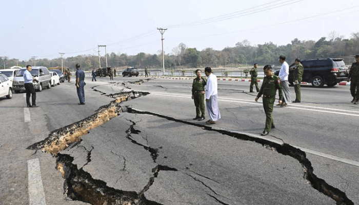 In this image provided by The Myanmar Military True News Information Team, Myanmar's military leader Senior Gen. Min Aung Hlaing, center, inspects damaged road caused by an earthquake Friday, March 28, 2025, in Naypyitaw, Myanmar. (The Myanmar Military True News Information Team via AP)