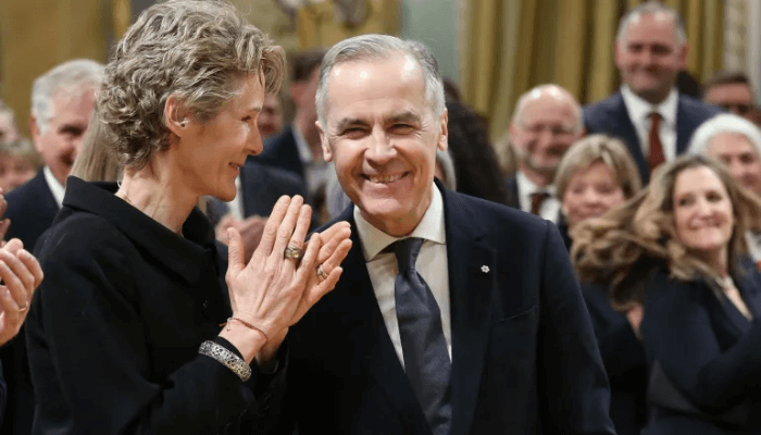 Prime Minister Mark Carney and his wife, Diana Fox Carney, arrive for his swearing-in ceremony at Rideau Hall on March 14, 2025 [Dave Chan/AFP]A showdown