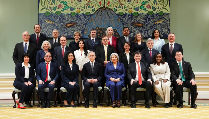 Carney, pictured in the centre, with his new cabinet ministers