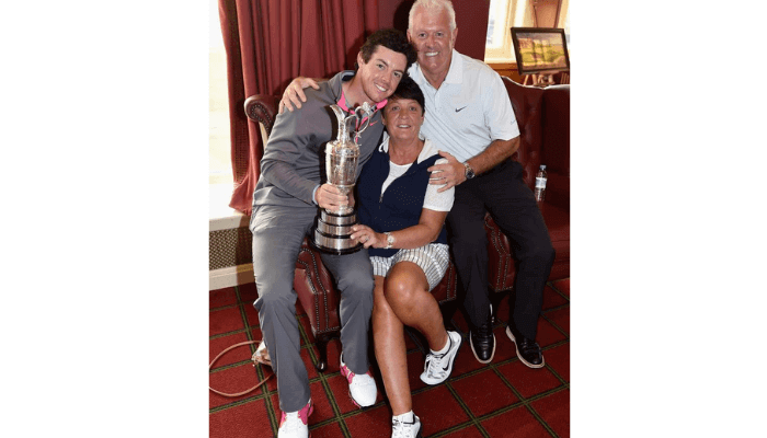 Rory and his mother Rosie and father Gerry pose with the Claret Jug after his two-stroke victory in The 143rd Open Championship at Royal Liverpool Golf club 