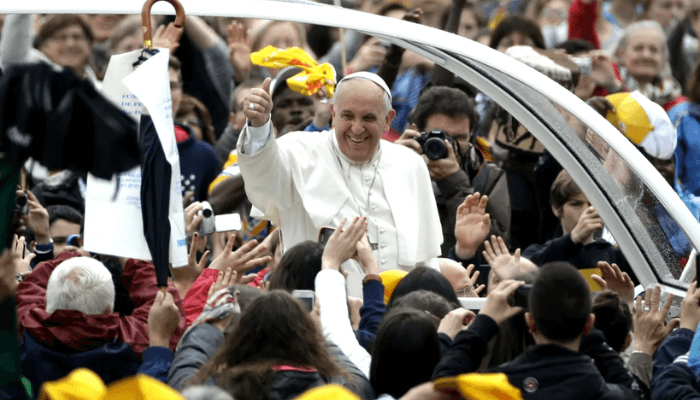 Francis waves to the faithful as he is driven to his weekly general audience in St Peter's Square at the Vatican on April 23, 2014. [Andrew Medichini/AP Photo]