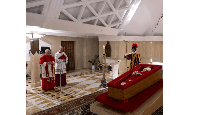 The body of Pope Francis lies in state at the Vatican’s Domus Sanctae Marthae chapel, surrounded by Swiss Guards, cardinals, and Vatican officials paying their respects before his transfer to St. Peter’s Basilica for public veneration, Monday, April 21, 2025. Credit: Vatican Media