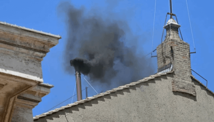 A second day of voting in the papal conclave began Thursday morning without a breakthrough, as black smoke once again billowed from the Sistine Chapel’s chimney, indicating that no new pope has been elected.
