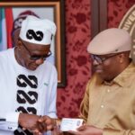 Siminalayi Fubara receiving membership card from Tony Okocha, Rivers State Chairman of APC