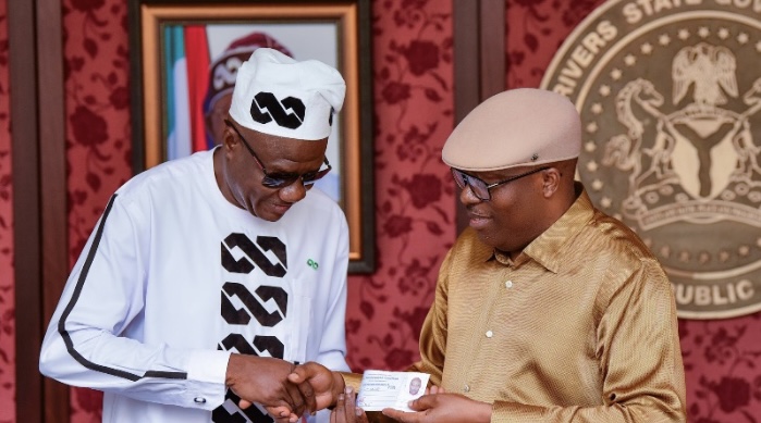 Siminalayi Fubara receiving membership card from Tony Okocha, Rivers State Chairman of APC